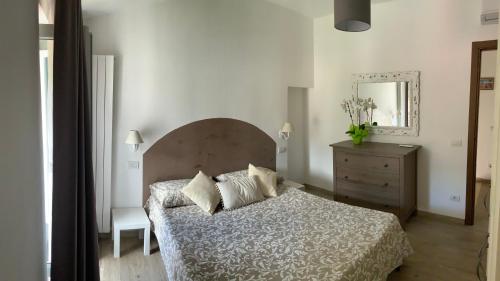 a bedroom with a bed and a dresser and a mirror at Casa La Wanda - Camaiore Toscana - 2 Br & Terrace in Camaiore