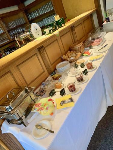 a long table with plates of food on it at Forsthaus Siehdichum in Dammendorf