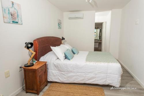 a bedroom with a bed and a lamp on a table at La Balsa in José Ignacio