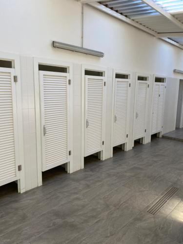 a row of white lockers in a room at KT-0094 Magnífica Tienda Tipi - Camping Miramar Playa in Torredembarra