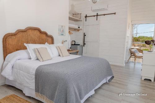 a bedroom with a large bed with a wooden headboard at La Balsa in José Ignacio
