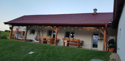 a house with a pavilion with benches and lights at Holiday Home Rojko in Štrigova