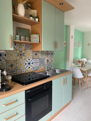 a kitchen with a sink and a stove top oven at Apulia Home in Zapponeta