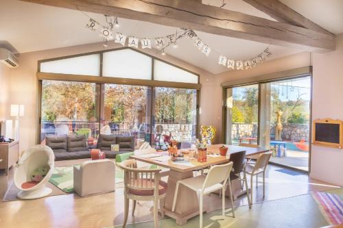 a living room with a table and chairs at Terre Blanche Hotel Spa Golf Resort in Tourrettes