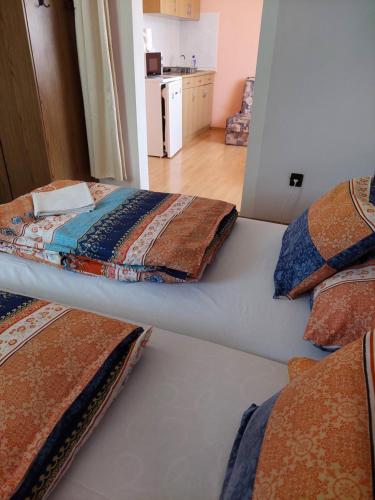 two beds with pillows on them in a room at Petra Vendégház in Bük
