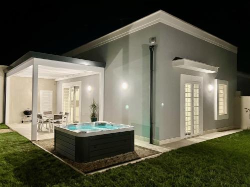a house with a hot tub in the yard at night at Domus Lavinia ''Levante'' - Anzio in Anzio