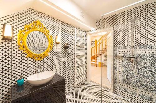 a bathroom with a sink and a shower with a mirror at Trevilles Art-Deco Józefina in Szklarska Poręba