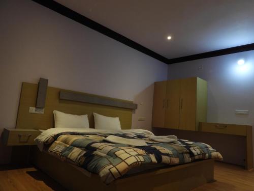 a bedroom with a large bed in a room at Babu Guest House in Leh