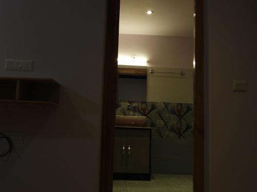 a bathroom with a sink and a mirror at Babu Guest House in Leh