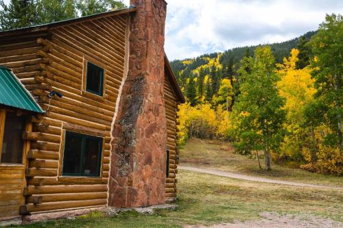 a log cabin in the woods next to a forest at Beyul Retreat in Meredith