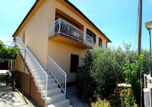 a house with stairs on the side of it at Apartments Nela in Jelsa