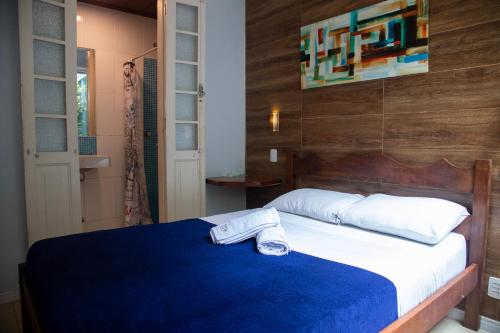 a bedroom with a bed with a towel on it at Mango Tree Ipanema in Rio de Janeiro