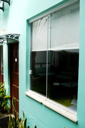 a glass window on the side of a building at Mango Tree Ipanema in Rio de Janeiro