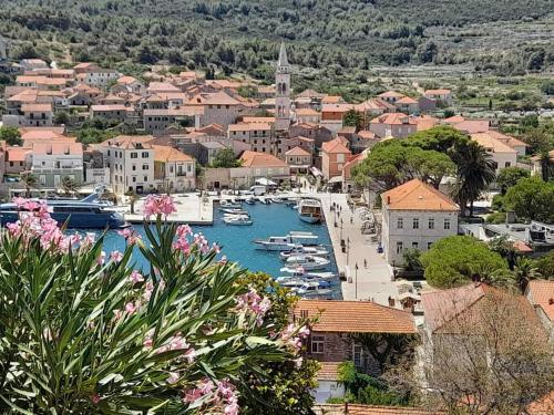 a small town with boats in a harbor at Apartments Nela in Jelsa