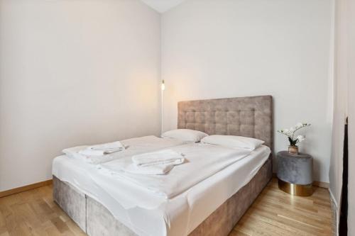 ein Schlafzimmer mit einem großen Bett mit weißer Bettwäsche in der Unterkunft Modern and new designer flat in Charlottenburg in Berlin