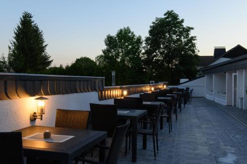 a row of tables and chairs on a patio at Angelo Spa Resort in Sankt Andreasberg