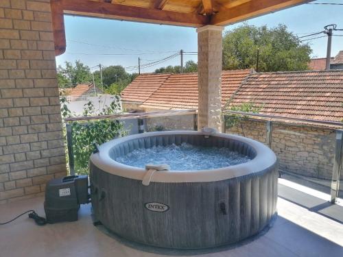 a large hot tub sitting on a patio at New, modern, luxury apartment Ivan with jacuzzi in Drinovci