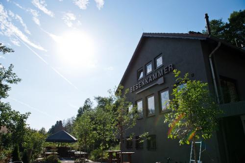 a building with a sign on the side of it at Tiny House Nature 3 - Green Tiny Village Harz in Osterode