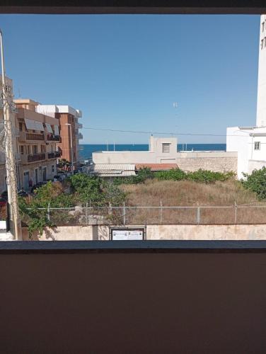 a view of the ocean from a window at fronte mare in Giovinazzo