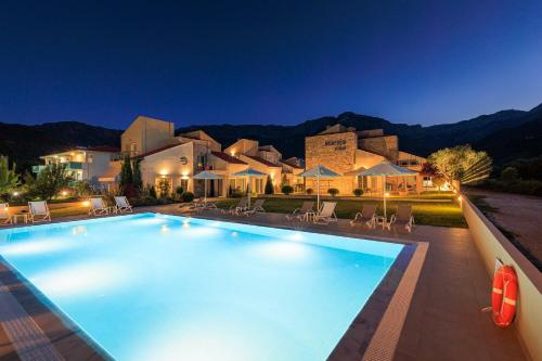 a large swimming pool in front of a house at Villas Marajo in Skala Potamias