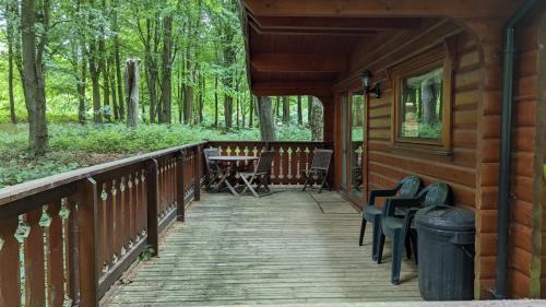 a wooden porch of a cabin with a table and chairs at Bamboo Retreat in Louth