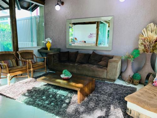 uma sala de estar com um sofá e uma mesa em Brisa da Costa Suites em Macaé