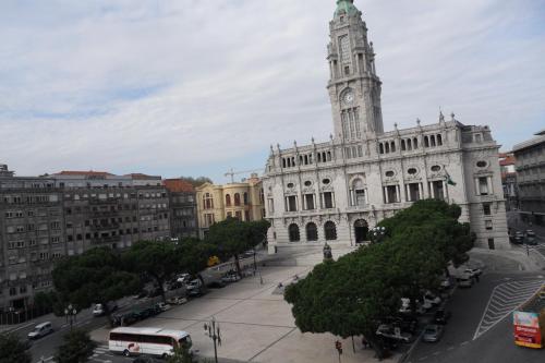 a large building with a clock tower in a city at Hotel Paulista in Porto
