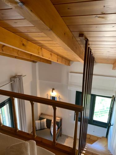 a staircase in a house with wooden ceilings at Villa Anna Kalamitsi Ideal for families in Kalamitsi