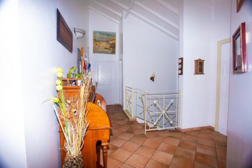 a hallway with white walls and a staircase with a table at Spacious Villa with Ocean and Mountain view-4 beds in Cul de Sac