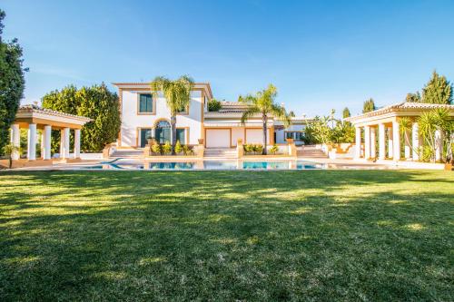 a house with a large yard with a pool at Cypress Villa in Albufeira