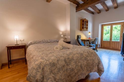 a bedroom with a bed and a desk and chairs at Peralta Zapatería in Cuenca