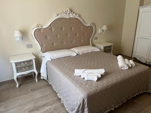 a bedroom with a large bed with towels on it at La Perla del Borgo B&B in Pisa