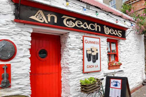 a building with a red door and a sign on it at Ashe Street in Clonakilty