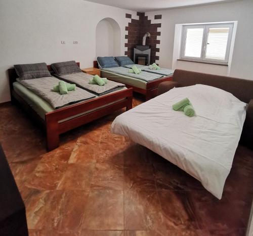 two beds and a couch in a room at APARTMA VATOVEC in Ankaran