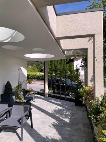 a patio with chairs and tables in a building at Hotel & Suites Glück Auf in Mayrhofen