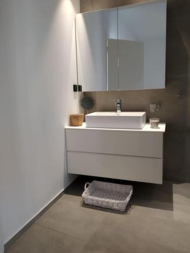 a bathroom with a white sink and a mirror at Casa Lagada Kos Private Residence. in (( Kermetés ))