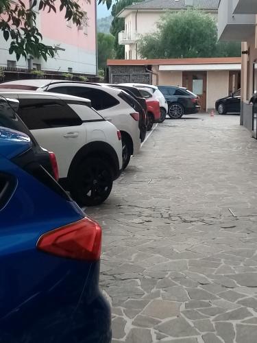 a row of cars parked in a parking lot at Hotel Aurora & Appartamenti in Nago-Torbole