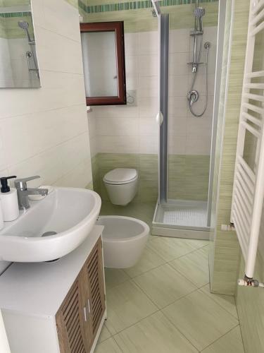 a bathroom with a sink and a toilet and a shower at Casa Oberdan - private parking in Monopoli