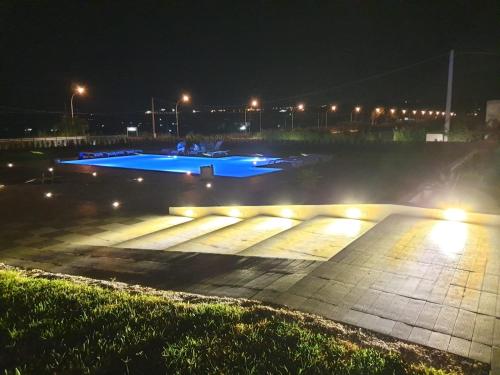 an empty parking lot at night with lights at Villa Giadel in Menfi