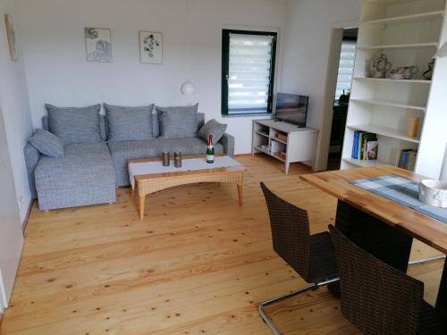 a living room with a couch and a table at Ferienhaus Regina in Neudorf