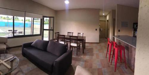 a living room with a couch and a table with chairs at Las Casitas y Los Duplex de Chacras de Coria in Chacras de Coria