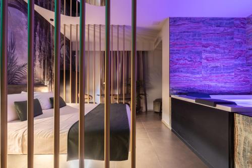 a bedroom with a large bed with purple lighting at Aquasuite - Luxury Experience & Spa in Palermo