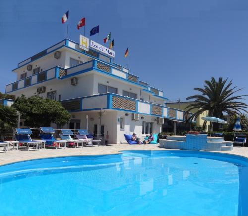 a large swimming pool in front of a hotel at Hotel Eco Del Mare in Marina di Massa