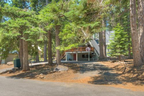 a house surrounded by trees with a driveway at Relaxation on Muletail in Carnelian Bay
