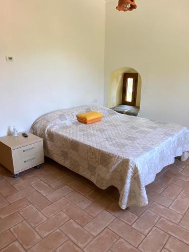 a bedroom with a bed with a yellow box on it at Mini Appartamenti Nonna Nella in Barbarasco