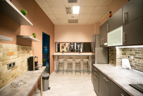 a kitchen with a counter and a bar in it at Bedway Athens Hostel in Athens