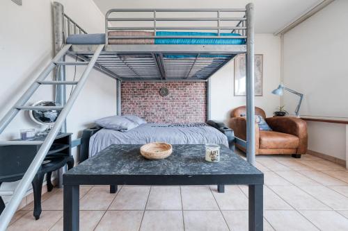 1 cama elevada con mesa en una habitación con 1 cama en La Chouette Illuminée à 45 minutes de Paris ideale jeux olympiques, en Ménilles