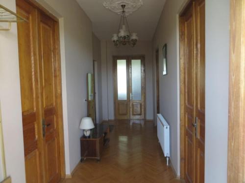 a hallway with two doors and a lamp on a table at Family Guest House Marso in Ssatschcheri