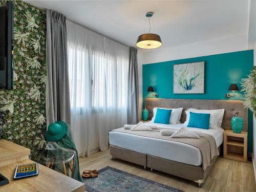 a bedroom with a large bed with blue walls at Acropolis City Life BH in Athens