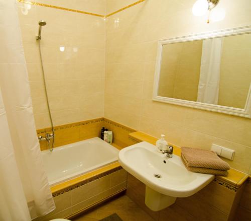 a bathroom with a sink and a bath tub at Lovely Dream Apartment in Vilnius